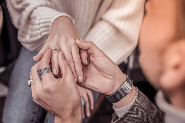 Close up of intertwined hands of future husband and wife - Valokuva, kuva