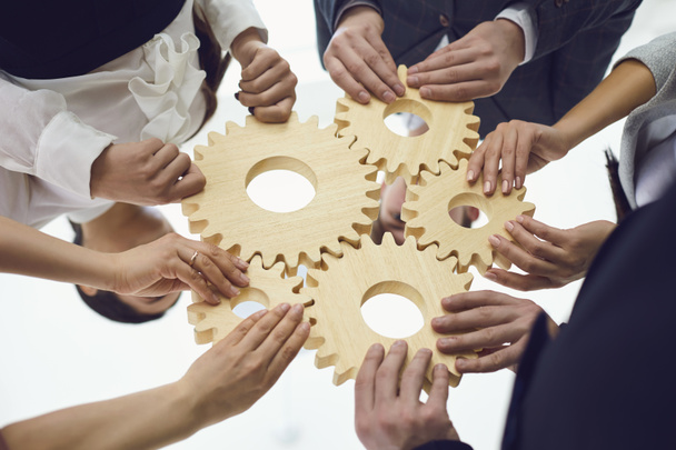 Teamwork concept.Group of businessmen with gears at the table at the workplace in the office. - Photo, Image