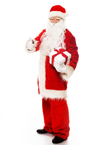 Weihnachtsmann präsentiert Geschenkbox isoliert auf weißem Hintergrund - Foto, Bild