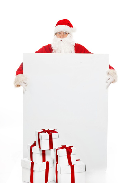 Άγιος Βασίλης με πολλά κουτιά δώρων και κενό πίνακα ανακοινώσεων - Φωτογραφία, εικόνα