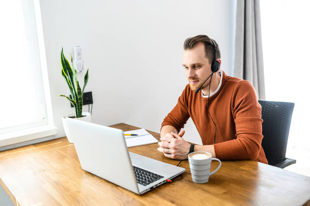 The guy uses hands-free headsets to work from home - Photo, Image