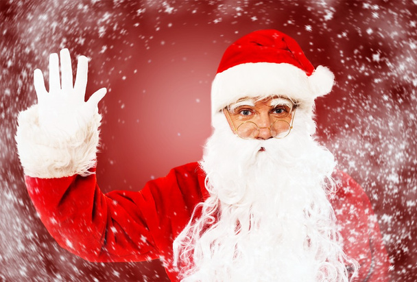 Santa claus tonen met gebaren iets - Foto, afbeelding