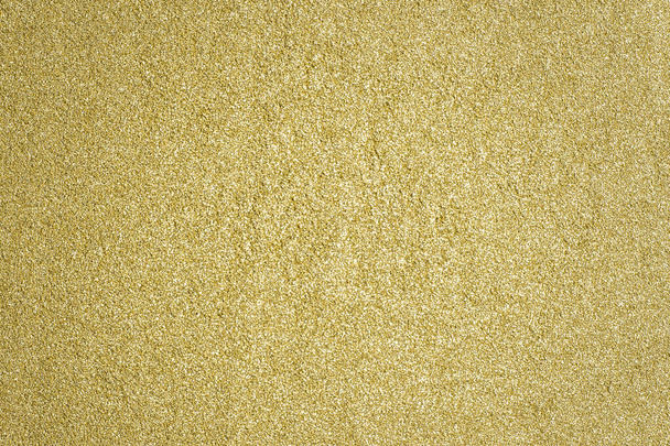 Detailed texture of glittering golden dust surface. Golden Shiny Wallpaper , Perfect for Christmas, New Year or any other Holidays Background. Golden fine powder. - Photo, Image
