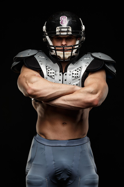 American football player wearing helmet and protective armour - Foto, Imagem
