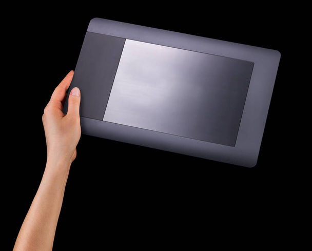 Hand holding graphic tablet for illustratorsand designers isolated on black - Photo, Image