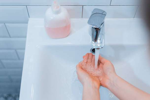 Woman wash his hands with soap to privent infection from coronavirus (COVID-19) - Fotografie, Obrázek