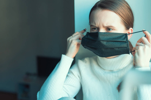 Young girl wear black mask to protect herself from virus spreading - Photo, Image