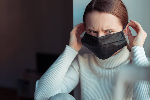 Young girl wear black mask to protect herself from virus spreading - Foto, afbeelding