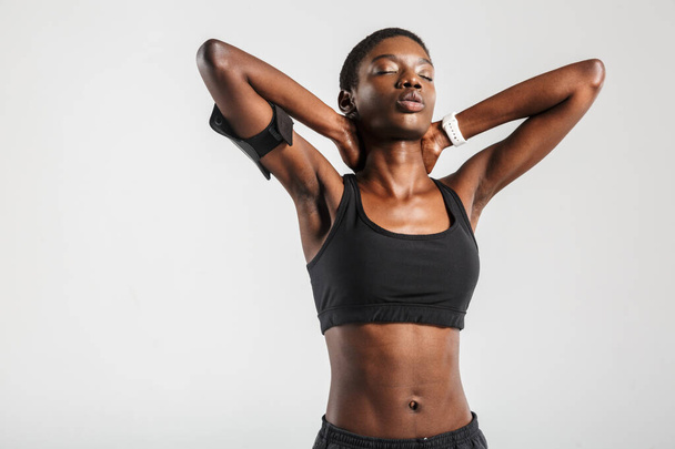 Image of african american sportswoman doing exercise while working out isolated over white background - Photo, Image