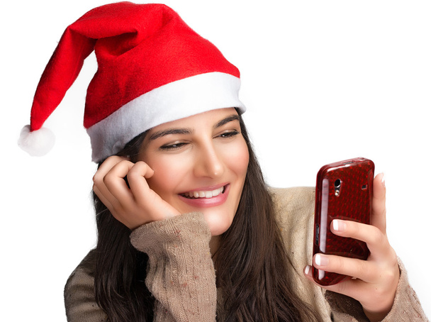 Χριστούγεννα κορίτσι με το χριστουγεννιάτικο δώρο. κινητό τηλέφωνο - Φωτογραφία, εικόνα