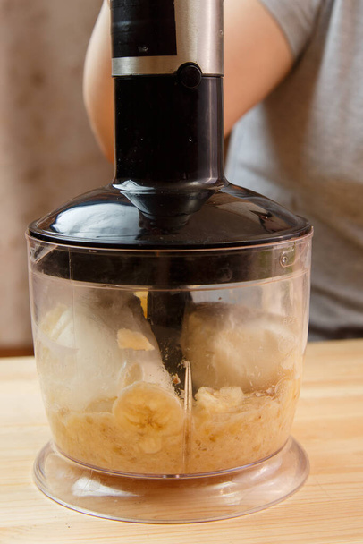 Banana slices in a blender bowl for mashed chopping. - Fotografie, Obrázek