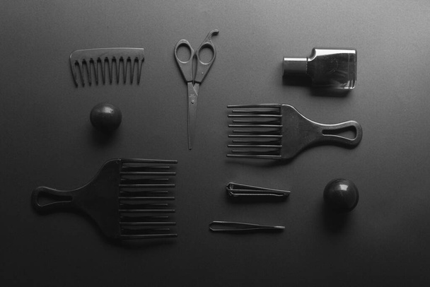 Set of hairdresser tools and accessories on dark background, dark mood concept - Foto, Bild