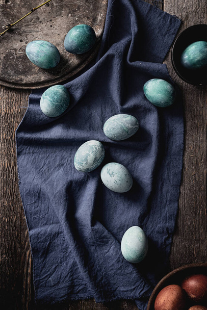 colored marble eggs of blue color on a blue background. View from above. - Photo, image