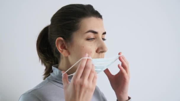 young woman wearing protective medical mask - Felvétel, videó