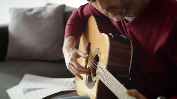 Tilt up βίντεο του ανθρώπου που παίζει ακουστική κιθάρα στο σπίτι. Πυροβολήθηκε με κόκκινη κάμερα ηλίου σε 8K. - Πλάνα, βίντεο