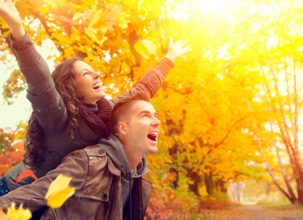 Happy Couple in Autumn Park. Fall. Family Having Fun Outdoors - Photo, Image