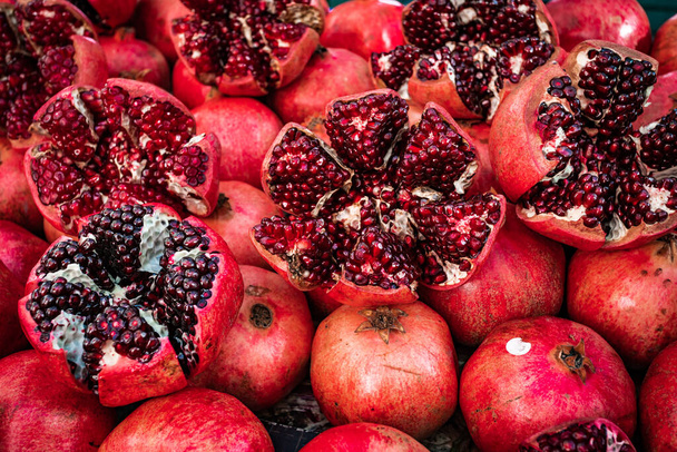 Many pomegranate cut in half, pomegranate background - Photo, Image