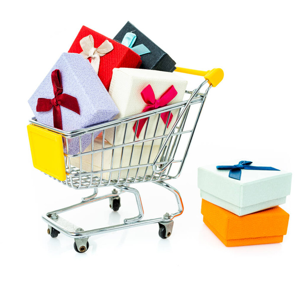 shopping cart with gifts isolated on white - 写真・画像