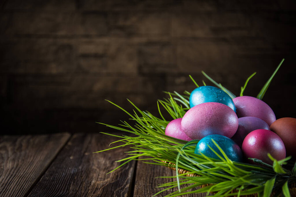 Easter colored eggs on a wooden background. - Φωτογραφία, εικόνα