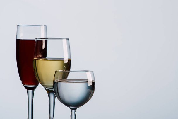 three wine glasses with different beverages - Valokuva, kuva
