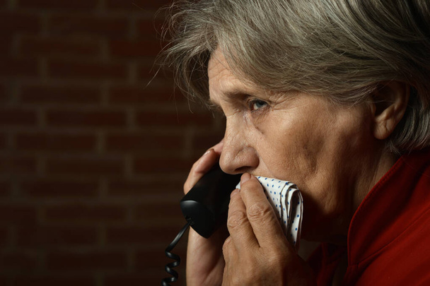 Portrait of ill senior woman calling doctor  - Valokuva, kuva