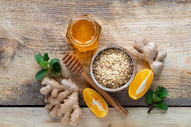 set of products to boost the immune system. Honey, lemon, nuts, ginger to Immunity boosting. top view. - Photo, image