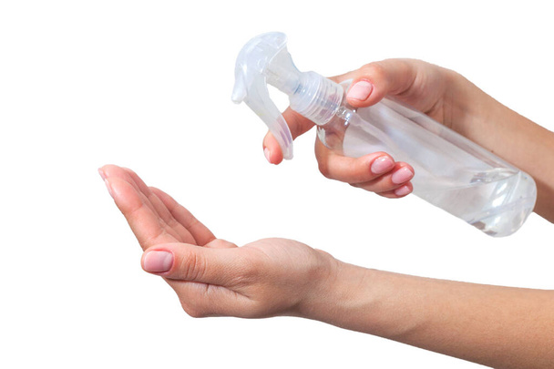 Hand disinfection. Lady's hand takes alcohol disinfectant spray on her hands. to prevent a viral epidemic. Isolated on a white background. Flu Prevention Properly clean and disinfect hands. - Photo, Image
