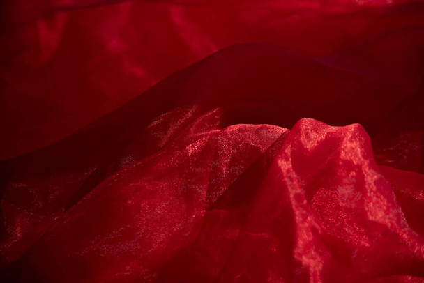 Organza red. Abstract background red chiffon organza. texture background pattern red silk fabric. This silk organza has a gentle open weave. - Fotó, kép