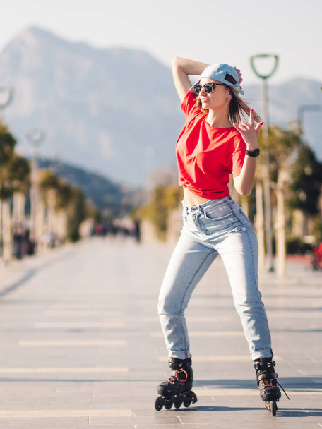 Young bright woman roller skating  - Foto, Bild