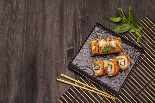 Grilled tiger prawn sushi. Japanese or Korean roll with different fresh ingredients. Trendy black wooden boards background - Photo, Image