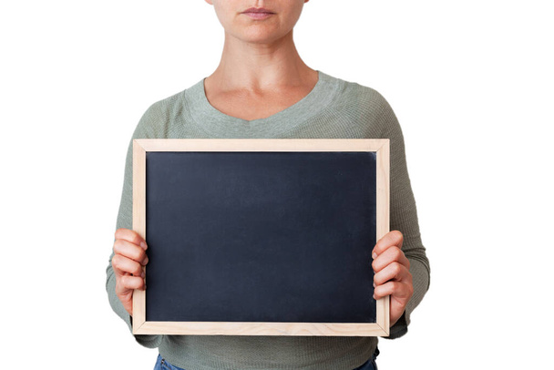 Female holding small framed blackboard with copy space in front of her body - Foto, imagen