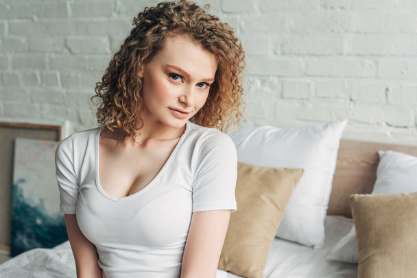 beautiful girl in homewear sitting on bed in morning   - Fotografie, Obrázek