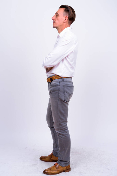Studio shot of mature handsome Italian businessman against white background - Fotó, kép
