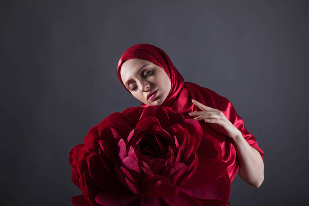 mysterious beautiful woman in the red silk dress of the Eastern Muslim peoples - Fotó, kép