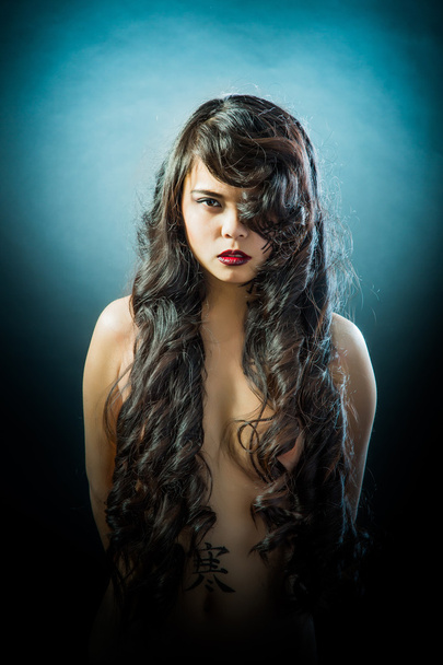 Beautiful brunette Asian woman with long black hair - Foto, Imagen