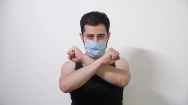Blanke man met medisch masker maakt een interessante beweging kijkt in camera Covid19 Coronavirus - Video