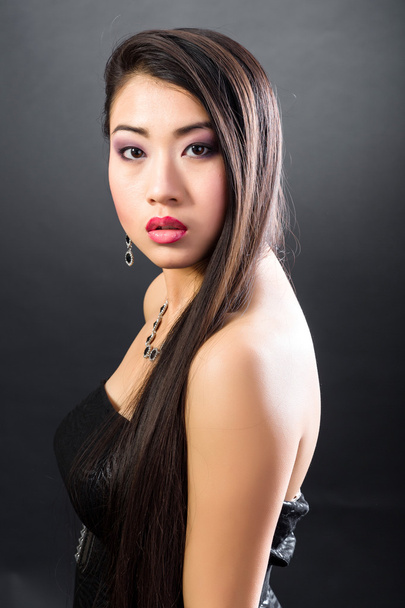 Beautiful brunette Asian woman with long black hair - Photo, Image