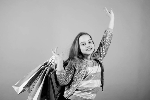 Shopping mall. Holiday purchase saving. Home shopping. Sales and discounts. Kid fashion. shop assistant with pack. Small girl with shopping bags. Happy child. Little girl with gifts. customer in mall - Photo, image