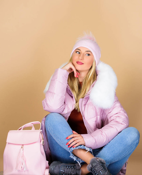 Girl wear outfit in pastel pink color. Little backpack and knitted hat. Total pastel outfit. Tender combination. Neutral color base. Pastel shades. Matching accessories. Dreamy sweet blonde girl - Foto, afbeelding