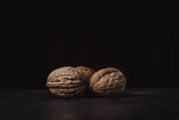 three nuts on a black background - Zdjęcie, obraz
