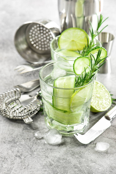 Drink with cucumber, lime, ice and rosemary - Photo, Image