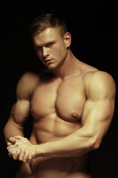 Handsome sport sexy stripped guy portrait on isolated black background - Fotografie, Obrázek