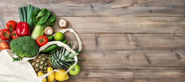 Fresh fruits vegetables in cotoon bag. Tomato, cucumber, broccoli, pineapple, apple, banane, salad. Healthy food - Fotoğraf, Görsel