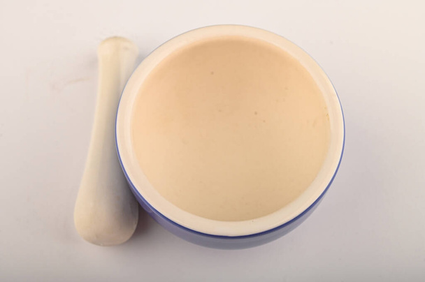 Blue ceramic spice mortar with pestle on white background. Close up - Photo, Image