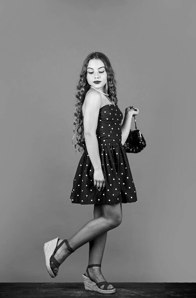 Fast fashion essentially business model companies that manufacture products. Retro fashion. Movement towards vintage fashion. Little girl makeup face curly hairstyle vintage outfit. Luxurious style - 写真・画像
