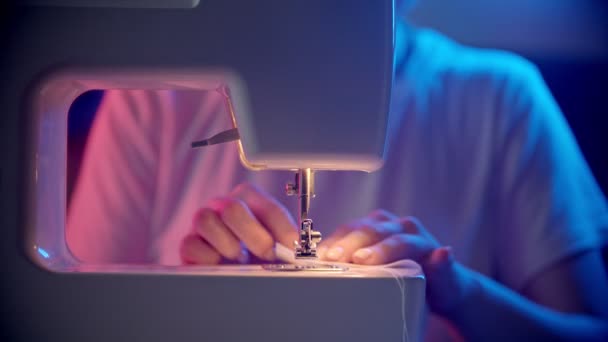 Young woman seamstress sewing a light white cloth - Footage, Video