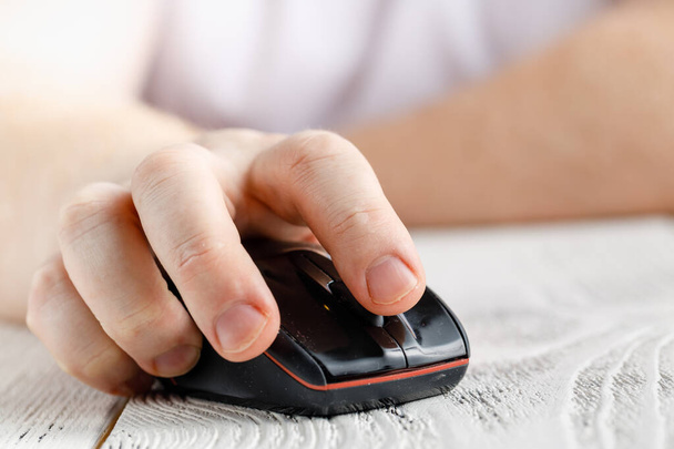 Closeup view of hand holding wireless mouse - 写真・画像