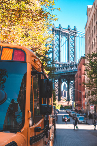 Brooklyn Bridge, New York, USA - 21 May, 2019: School bus in Brooklyn with a Manhattan bridge in the background. - Fotó, kép
