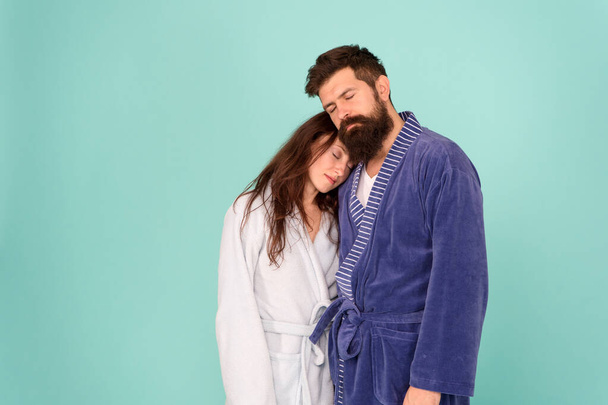 Drowsy and weak in morning. Advice relationships surviving quarantine. Morning routine. Couple sleepy faces domestic clothes. All day pajamas. Sleepy people blue background. Couple in love bathrobes - Фото, изображение