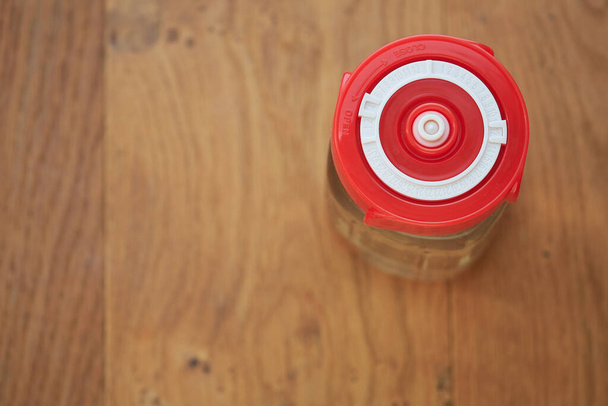 Una toma aérea de un frasco de vidrio que contiene kéfir de agua y sellado con una tapa de fermentación de color rojo brillante que indica la fecha actual. Concepto de vida saludable bebida orgánica, casero, bricolaje, salud intestinal
 - Foto, Imagen